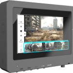 A rugged Diamond Ultra display screen shows surveillance footage of a deserted, dilapidated urban area. The interface includes control buttons labeled CH1 to CH4 and MAINT.